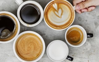 mugs with various coffee drinks in them, placed in a circle